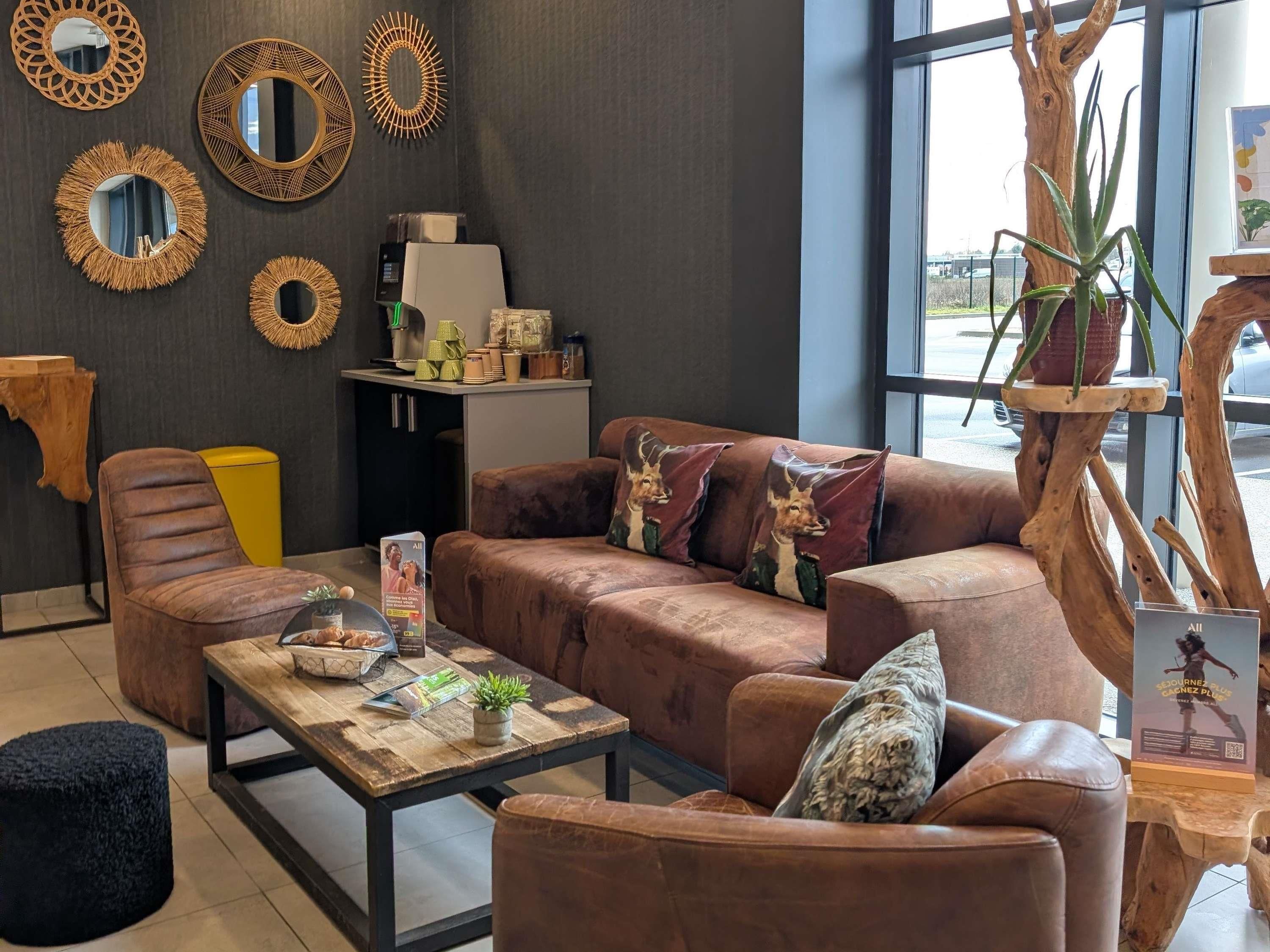 A modern living room with a brown leather sofa, a wooden coffee table, and decorative mirrors on the wall.