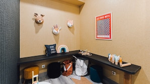A room with a black counter, a bulletin board with a poster, and wall-mounted animal head decorations. - ibis Styles Contres Cheverny (Le Controis en Sologne)