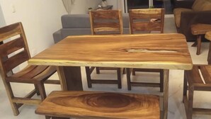 A wooden dining table with six chairs, a sofa, and a small side table in a living room. - Jazmin Del Sol - Just Steps Away to the Beautiful Potrero Beach (Potrero)