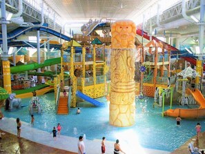 An indoor water park with slides, a large central water column, and various play structures. - Mountain Manor!★New Hot Tub!!★Secluded 7BR3BA Home (Blakeslee)