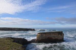 A coastal landscape with rocky formations and waves. - Lighthouse Ranch with Expansive Ocean and Pasture Views (Point Arena)