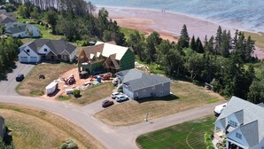 An aerial view of a residential area with houses, a beach, and a forest. - Waterview 5 bedroom home.  Sleeps 10 (Cornwall)