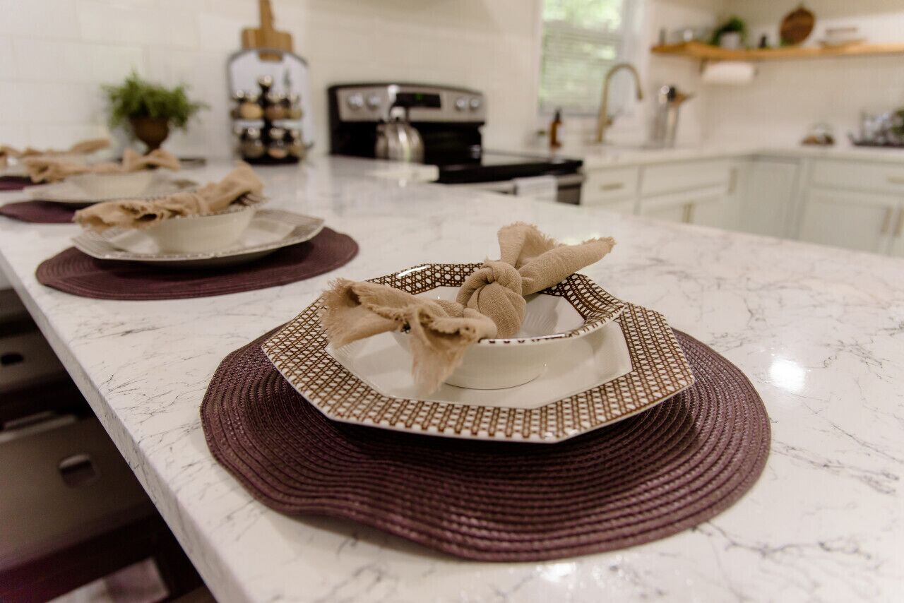 A kitchen counter with a marble surface, a toaster, and a coffee maker.