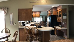 A home interior with a kitchen, dining area, and living space. - Beautiful spacious house with spectacular  views of Lake Pepin (Lake City)
