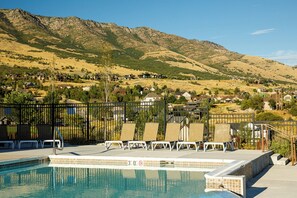 A swimming pool with lounge chairs and a view of a mountainous landscape. - 3 Ski Resorts, Hiking, 2 King Bds, Private Hot Tub (Eden)