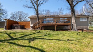 A two-story house with a wooden deck and a covered outdoor area. - Cozy Getaway with a View! (Trenton)