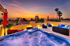 A rooftop pool area with lounge chairs and a hot tub, overlooking a sunset view. - Ocean Views - Walk to Beach - La Jolla - A/C - Rooftop Deck! (San Diego)