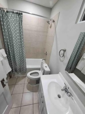 Bathtub, hair dryer, towels, soap