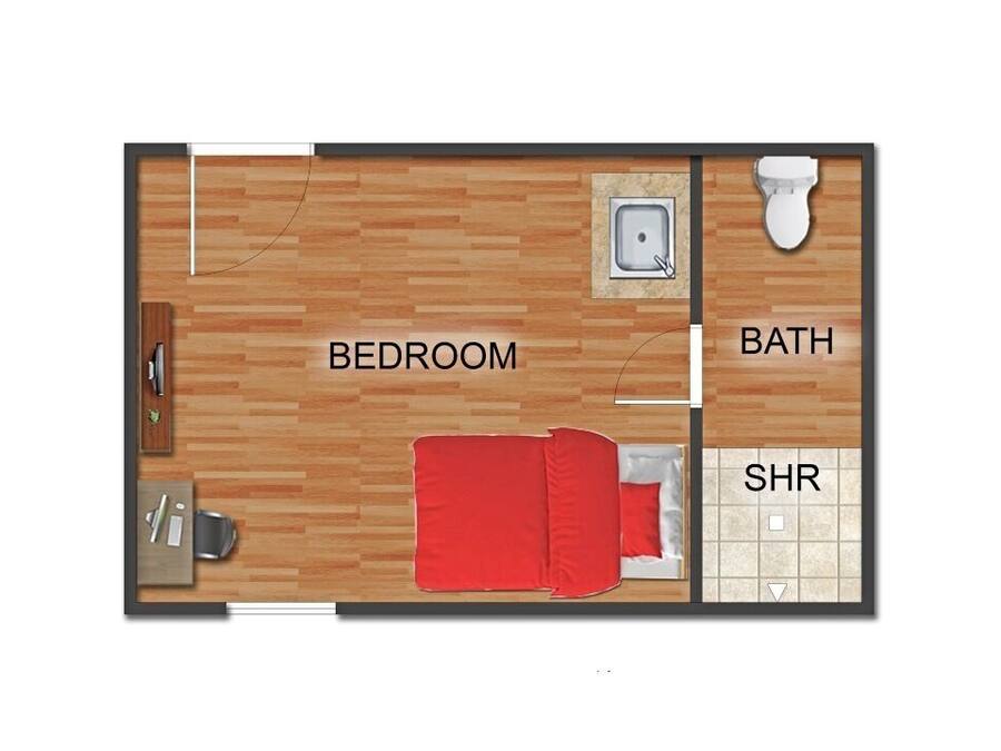 Ein Schlafzimmer mit Bett, ein Badezimmer mit Toilette und einer Duschkabine.