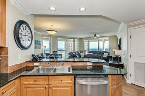 Enjoy cooking in this well-equipped kitchen with a central island, sink, and dishwasher.