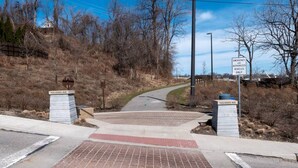 A gated driveway leading to a building with a sign indicating 'Emergency and Authorized Vehicles Only'. - Tremont! 7 min to downtown Cle (Cleveland)