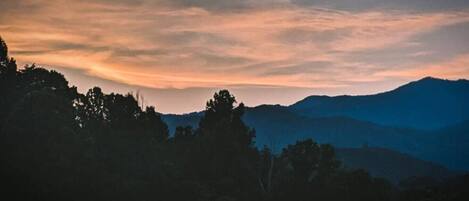 A mountainous landscape with a sunset.