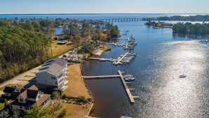 A marina with boats docked, a bridge in the background, and residential buildings nearby. - Waterfront Views & Boat Slip, Blackwell Point #B (Oriental)