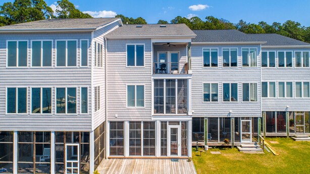 A modern multi-story residential building with large windows, a deck, and a visible balcony. - Waterfront Views & Boat Slip, Blackwell Point #B (Oriental)