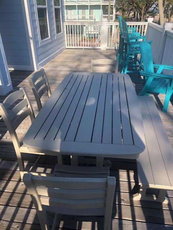 A covered outdoor patio with a table and chairs.