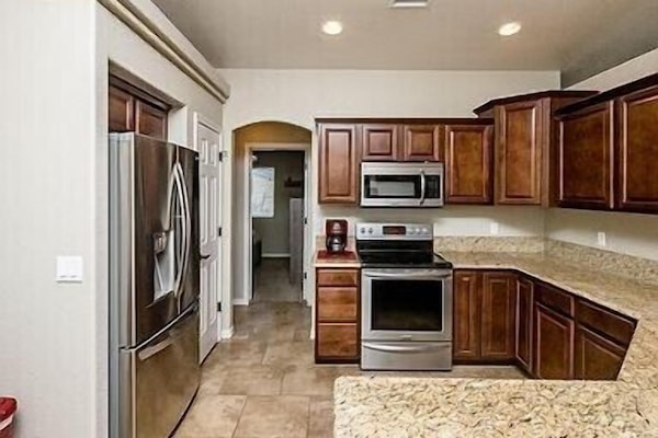 Kitchen — w/stainless steel appliances and granite countertops.