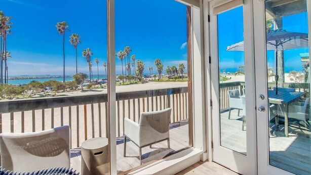 A balcony with a view of palm trees and the ocean. - Ocean Front * Panoramic Water View Deck * A/C (San Diego)