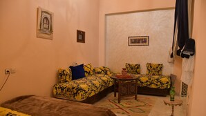 A room with a sofa bed, a smaller bed, a small table, and a decorative vase. - Rent room at Riad Alkatib in the heart of the Medina Meknes (MEKNES)