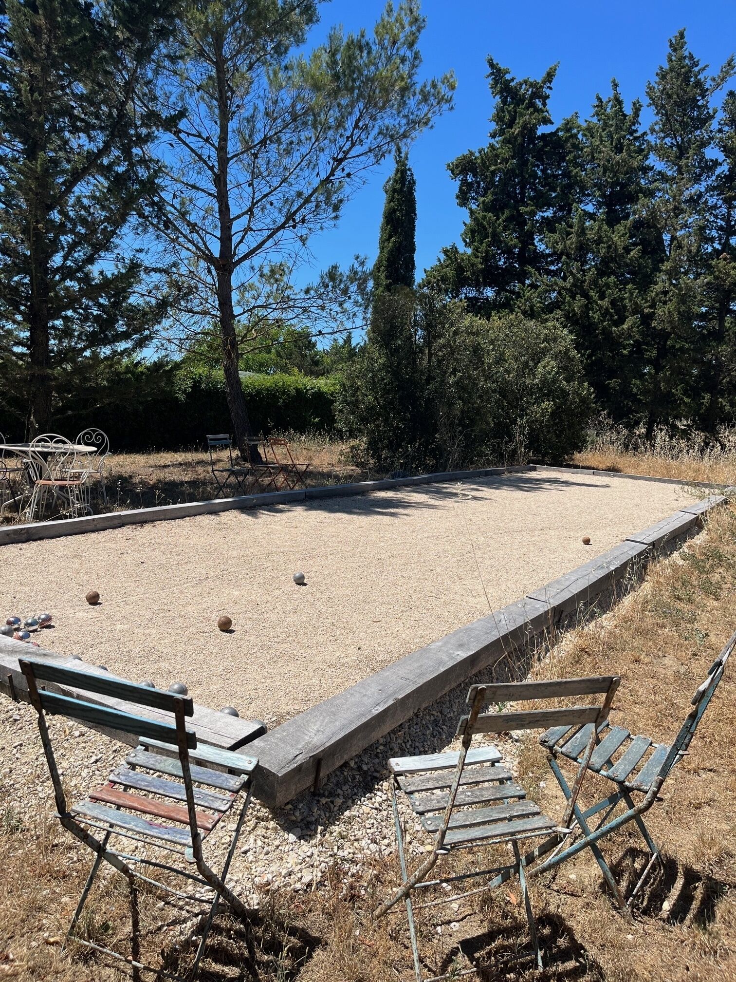 A billiards table with surrounding seating and a gravel area.