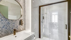 A modern bathroom with a large mirror, a sink, and a toilet. - 4bed/4bath, Luxury AND Calm, 10min Walk From Beach (Cannes)