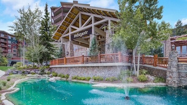 A pool area with a wooden bridge and a sign reading "Westgate."