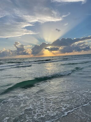 A beach with waves and a sunset. - Captain's Cove waterfront condo with shared heated pool (Indian Shores)