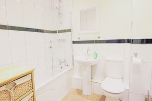 Combined shower/bathtub, towels, soap, toilet paper
