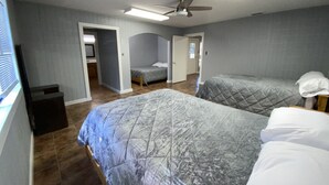 A bedroom with two beds, a ceiling fan, and a window. - Casa Amigos (Concan)