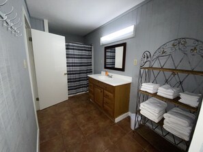 Combined shower/bathtub, hair dryer, towels, toilet paper
