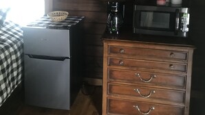 A compact kitchen with a refrigerator, microwave, coffee maker, and a wooden dresser. - Maggie Valley Cabin off the Blue Ridge Pkwy. (Maggie Valley)