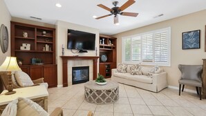 A living room with a fireplace, television, and comfortable seating. - Large Family home near Sequoia National Park (Visalia)