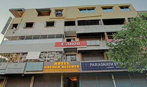 A multi-story building with various businesses including a Canon store, Hotel Golden Heights, and Parasnath Education. - Treebo Golden Heights (Golmuri)