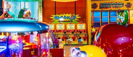 An indoor amusement arcade with various game machines and a prominent 'Showboat Atlantic City' sign.