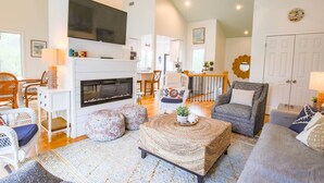 A spacious living room with a fireplace, comfortable seating, and a television. - 2 Minute Walk to Beach; Access to Community Pool and Pickle Ball, Basketball & Tennis Courts (Isle of Palms)