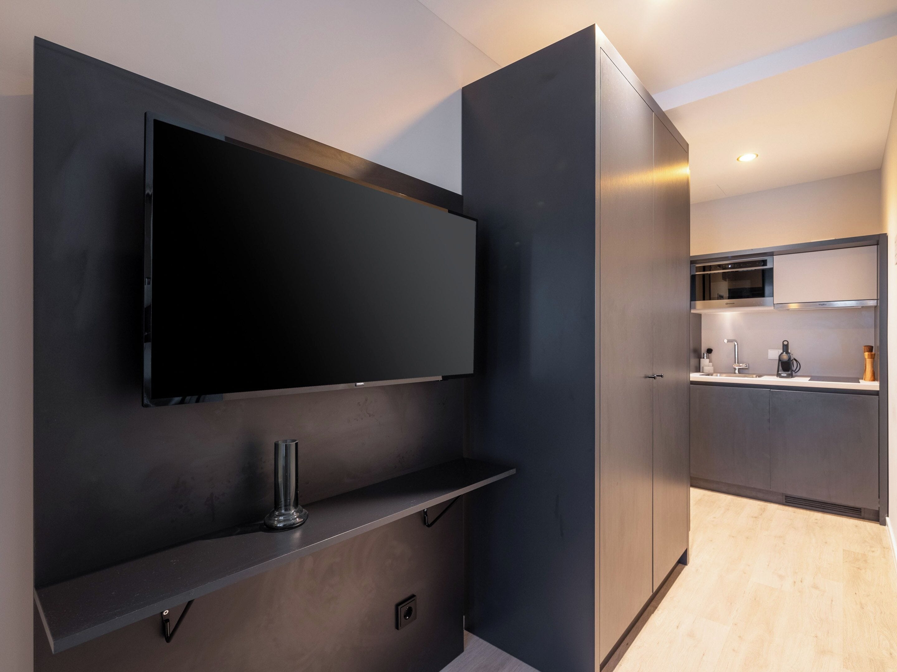 A modern kitchen with a built-in microwave, a sink, and a countertop.