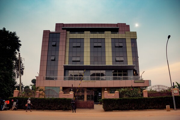 A modern hotel with a symmetrical facade, large windows, and a gated entrance. - Kenlon Hotel (Kampala)