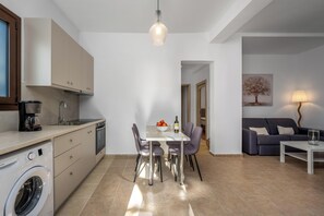 A compact living space with a kitchen, dining area, and seating area.