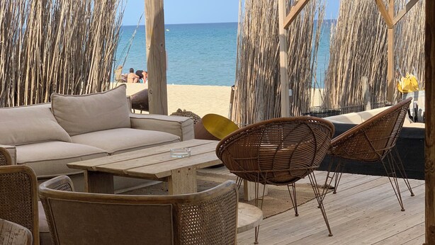 A covered outdoor seating area with a view of the beach and ocean. - Spacious 2 bed Appartment full air con, Sun terrace,stunning views, Pools (Fitou)