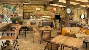 A rustic interior with wooden furniture, a kitchen area, and a mural of a leopard. - Spacious 2 bed Appartment full air con, Sun terrace,stunning views, Pools (Fitou)