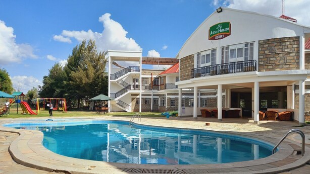 A resort with a swimming pool, outdoor seating, and a playground. - Athi Holiday Resort (Athi River)