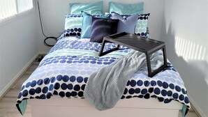 A bedroom with a bed, pillows, a bedside table, and a wall-mounted sign. - Beachside Escape, WiFi & Pet-Friendly | Riptide (Lilli Pilli)