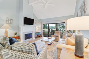 A living room with a fireplace, television, and seating area.