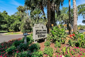 A sign for Inverseness Village with a road number 60 sign.