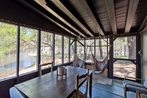 Large screened in porch with table & hammock swings
