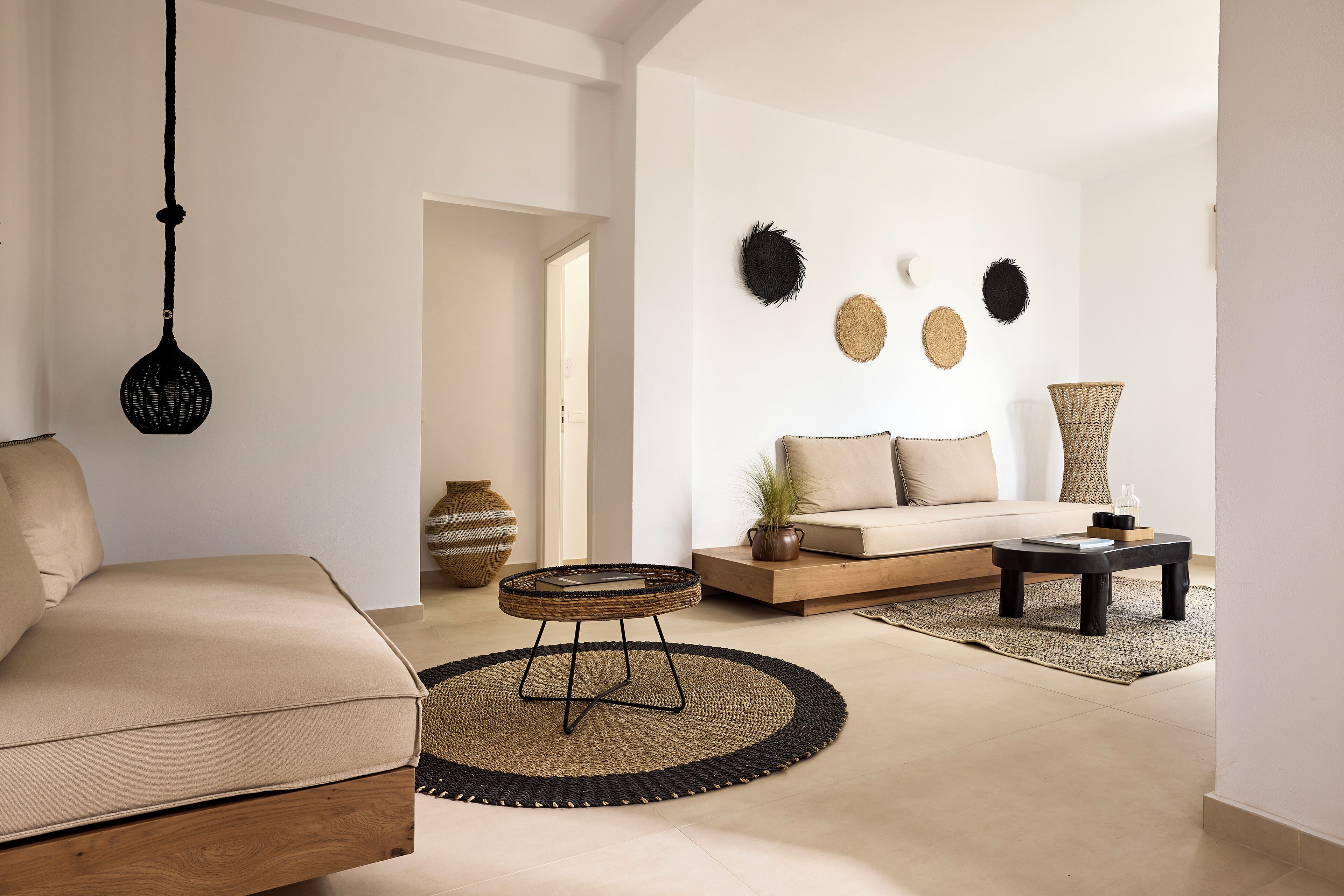 A modern living room with a sofa, round coffee table, and decorative wall art.