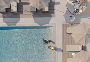 Seasonal outdoor pool, open 9:00 AM to 9:00 PM, pool umbrellas