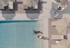 Seasonal outdoor pool, open 9:00 AM to 9:00 PM, pool umbrellas