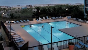 A swimming pool with lounge chairs and a view of the beach and ocean. - Ocean & Bay Views, Resort Amenities, Weekly Activities & Fireworks! - Book Now (Ocean City)