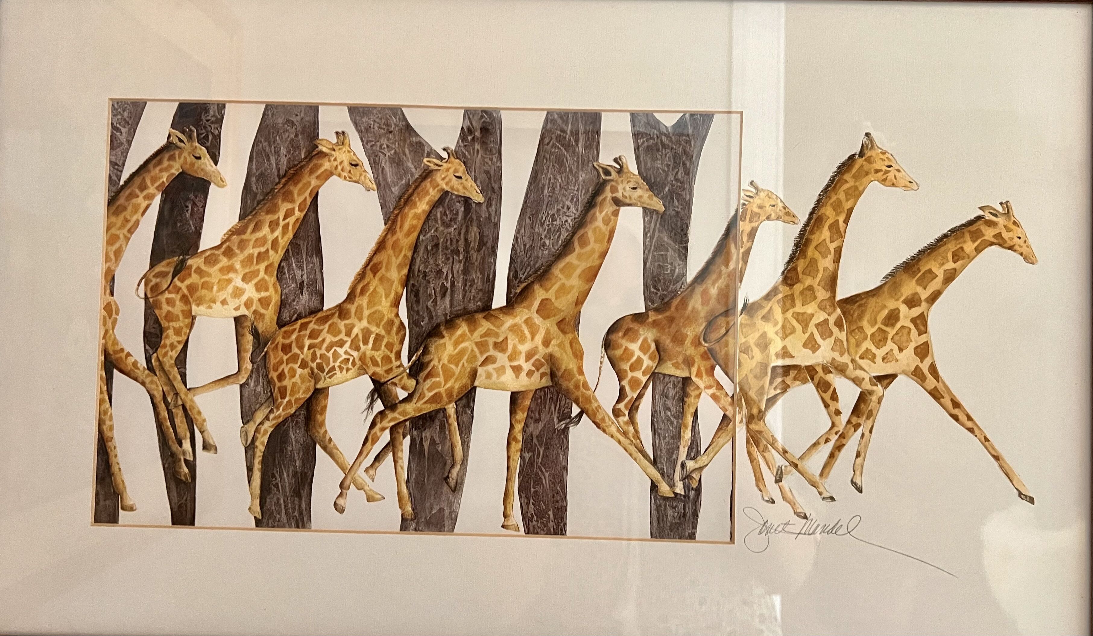 En inramad tavla som föreställer springande giraffer.
