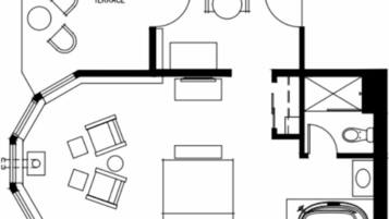 Plànol d'una habitació d'hotel amb terrassa, un llit, un bany i zona de dinar.